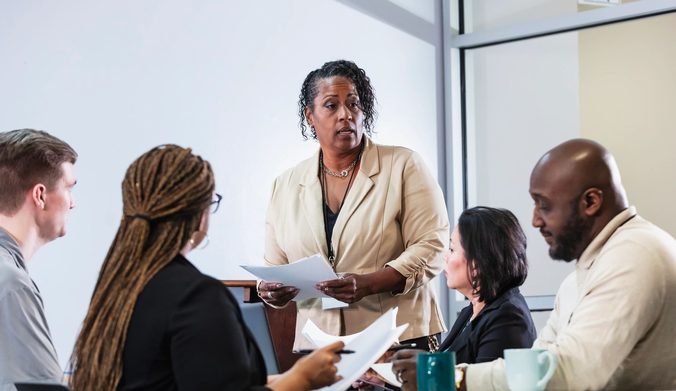 Leader guiding a team discussion around a table