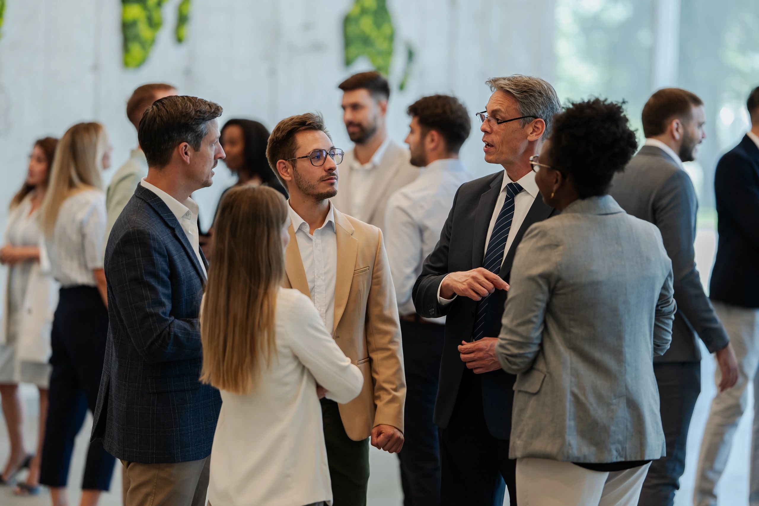 Professionals networking and discussing ideas at a corporate event